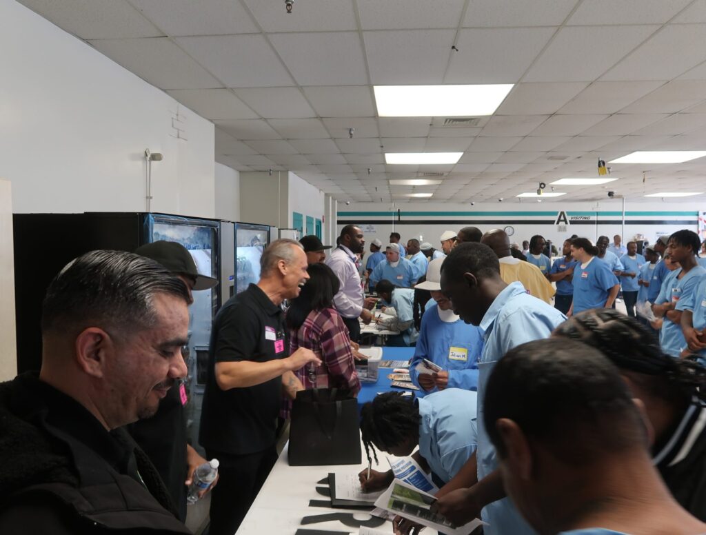 A photo of participants in the event engaging and signing in at the event.